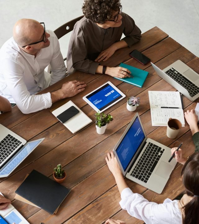 High angle view of a diverse team in a modern office setting discussing a business project.